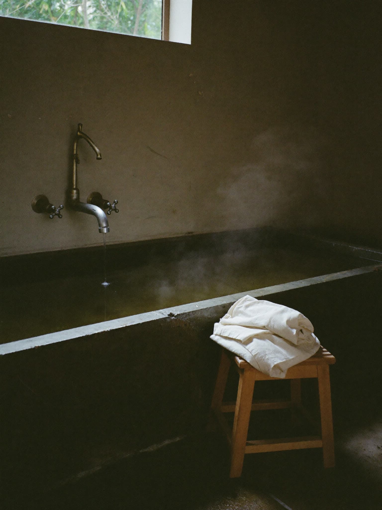 A bath cut from river stone